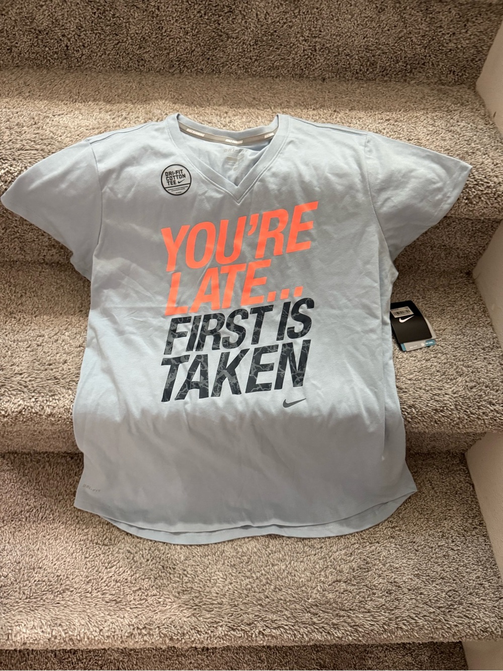 Nike Women's Light Blue Tee with Orange and Black Graphic
